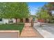 Charming home with inviting walkway, lush lawn, and mature trees providing curb appeal at 307 E Catalina Dr, Phoenix, AZ 85012