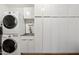 Functional laundry room with washer, dryer, sink, and ample cabinet space at 307 E Catalina Dr, Phoenix, AZ 85012