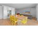 Bright living room featuring a dining table, modern kitchen and hardwood floors at 307 E Catalina Dr, Phoenix, AZ 85012