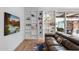 Bright living room featuring a bookshelf, modern couch, hardwood floors, and a television at 307 E Catalina Dr, Phoenix, AZ 85012