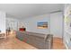 Bright living room featuring a modern couch, television and hardwood floors at 307 E Catalina Dr, Phoenix, AZ 85012