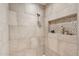Elegant walk-in shower features custom tile work and a decorative inset shelf at 307 E Catalina Dr, Phoenix, AZ 85012