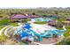 Aerial view of community amenities including a water park, pool, and recreation center with mountain views at 3613 W Plymouth Dr, Anthem, AZ 85086