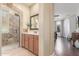 Bathroom featuring a walk-in shower with stylish tile and glass door, and a vanity with a framed mirror at 3613 W Plymouth Dr, Anthem, AZ 85086