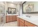 Bathroom with a double sink vanity with framed mirrors, tile flooring, and glass enclosed shower at 3613 W Plymouth Dr, Anthem, AZ 85086