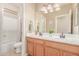 Bathroom featuring a double sink vanity, tub/shower combo, and light colored walls at 3613 W Plymouth Dr, Anthem, AZ 85086