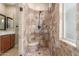 Updated bathroom highlighting a tiled walk-in shower with bench seating and a decorative shower head at 3613 W Plymouth Dr, Anthem, AZ 85086