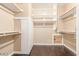Walk-in closet featuring wood flooring, multiple shelves, and a compact design for optimal storage at 3613 W Plymouth Dr, Anthem, AZ 85086
