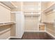 Spacious walk-in closet featuring custom shelving and hardwood floors at 3613 W Plymouth Dr, Anthem, AZ 85086