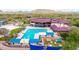 Resort-style community pool boasts a large pool area, clubhouse, umbrellas, and comfortable lounge chairs at 3613 W Plymouth Dr, Anthem, AZ 85086
