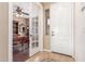 Inviting entryway featuring a decorative tile floor, white front door and study access with glass doors at 3613 W Plymouth Dr, Anthem, AZ 85086