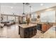 Open kitchen with granite counters, a center island, pendant lighting, and views to the living room at 3613 W Plymouth Dr, Anthem, AZ 85086