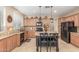 Spacious kitchen featuring granite countertops, black appliances, and center island with seating at 3613 W Plymouth Dr, Anthem, AZ 85086
