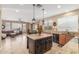 Open-concept kitchen view to living room, showcasing a large island with pendant lighting and granite countertops at 3613 W Plymouth Dr, Anthem, AZ 85086