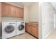 Convenient laundry room with modern washer and dryer and built-in cabinets at 3613 W Plymouth Dr, Anthem, AZ 85086
