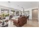 Bright living room with tile flooring, chandelier, and ample seating at 3613 W Plymouth Dr, Anthem, AZ 85086