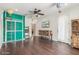 Large living space with wood floors, a decorative ladder, a TV, and hot air balloon decor at 3613 W Plymouth Dr, Anthem, AZ 85086