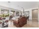 Bright living area with modern tile floors, elegant lighting, and views of the outdoor living space at 3613 W Plymouth Dr, Anthem, AZ 85086