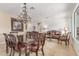 Open-concept living space featuring a dining set, comfortable seating, and stylish chandelier at 3613 W Plymouth Dr, Anthem, AZ 85086