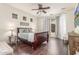 Serene main bedroom boasts hardwood floors, a ceiling fan, and large windows with sheer curtains at 3613 W Plymouth Dr, Anthem, AZ 85086