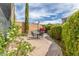 Charming outdoor patio features a table, chairs, and lush landscaping, perfect for relaxing or entertaining at 3613 W Plymouth Dr, Anthem, AZ 85086