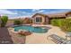 Lush private pool surrounded by rock landscaping, a rock waterfall feature, and patio seating at 3613 W Plymouth Dr, Anthem, AZ 85086
