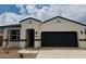 New single-Gathering home features a two-car garage and a charming front entrance at 39985 W Agave Rd, Maricopa, AZ 85138