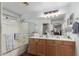 Bathroom with a double sink, shower, and a large mirror at 4043 S Shady Ct, Gilbert, AZ 85297