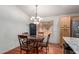 Dining room with a chandelier, wooden table, and blinds on the window at 4043 S Shady Ct, Gilbert, AZ 85297