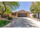 Charming single-Gathering home with a well-maintained yard, a two-car garage, and desert landscaping at 4043 S Shady Ct, Gilbert, AZ 85297