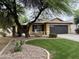Charming single-Gathering home with mature landscaping, green lawn, and a two car garage at 4043 S Shady Ct, Gilbert, AZ 85297