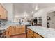 Open kitchen with wood floors, granite countertops, cabinets, stainless steel appliances, and adjacent living area at 4043 S Shady Ct, Gilbert, AZ 85297