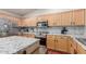 Modern kitchen featuring light wood cabinets, granite countertops, stainless steel appliances, and tile backsplash at 4043 S Shady Ct, Gilbert, AZ 85297