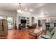 Spacious living room with hardwood floors, built-in shelving, and open floor plan filled with natural light at 4043 S Shady Ct, Gilbert, AZ 85297