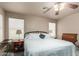 Main bedroom with a ceiling fan, carpet, and lamps on the nightstands at 4043 S Shady Ct, Gilbert, AZ 85297