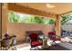 Covered patio with overhead lights and chairs with view of yard at 4043 S Shady Ct, Gilbert, AZ 85297