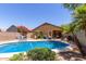 Backyard pool with patio furniture, desert landscaping, and a covered patio is ready for outdoor enjoyment at 4043 S Shady Ct, Gilbert, AZ 85297