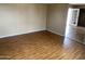 Inviting living room with wood-look flooring and ample natural light, perfect for relaxation and entertaining at 4119 N 105Th Ln, Phoenix, AZ 85037