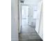 Bright hallway with fresh gray flooring leading to various rooms in the house at 4124 N 81St St, Scottsdale, AZ 85251