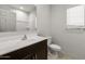 Well-lit bathroom with a dark vanity, large mirror, and a shower-tub combo at 42885 W Vincent Dr, Maricopa, AZ 85138