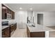 Elegant kitchen with dark wood cabinets, stainless steel appliances, granite countertops, and a functional island for food preparation at 42885 W Vincent Dr, Maricopa, AZ 85138