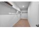 Spacious walk-in closet with shelves and carpet at 42885 W Vincent Dr, Maricopa, AZ 85138