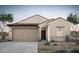 Charming single-story home featuring desert landscaping, a two-car garage, and a classic tile roof at 42895 W Vincent Dr, Maricopa, AZ 85138
