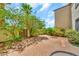 Enclosed backyard brick patio features lush greenery, a privacy wall, and access gate at 4301 N 21St St # 3, Phoenix, AZ 85016
