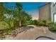 Enclosed backyard brick patio features lush greenery, a privacy wall, and access gate at 4301 N 21St St # 3, Phoenix, AZ 85016