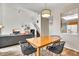 Open dining area with views into the living room and modern light fixture at 4301 N 21St St # 3, Phoenix, AZ 85016
