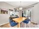 Bright dining room featuring wood floors, modern light fixture, and a sliding glass door to the patio at 4301 N 21St St # 3, Phoenix, AZ 85016