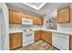 Kitchen featuring bright wood cabinetry, white appliances, and wood floors at 4301 N 21St St # 3, Phoenix, AZ 85016