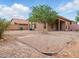 Backyard with gravel, patio, and large shade tree at 44010 W Wade Dr, Maricopa, AZ 85138