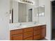 Double vanity in the bathroom featuring two sinks and neutral decor at 44010 W Wade Dr, Maricopa, AZ 85138